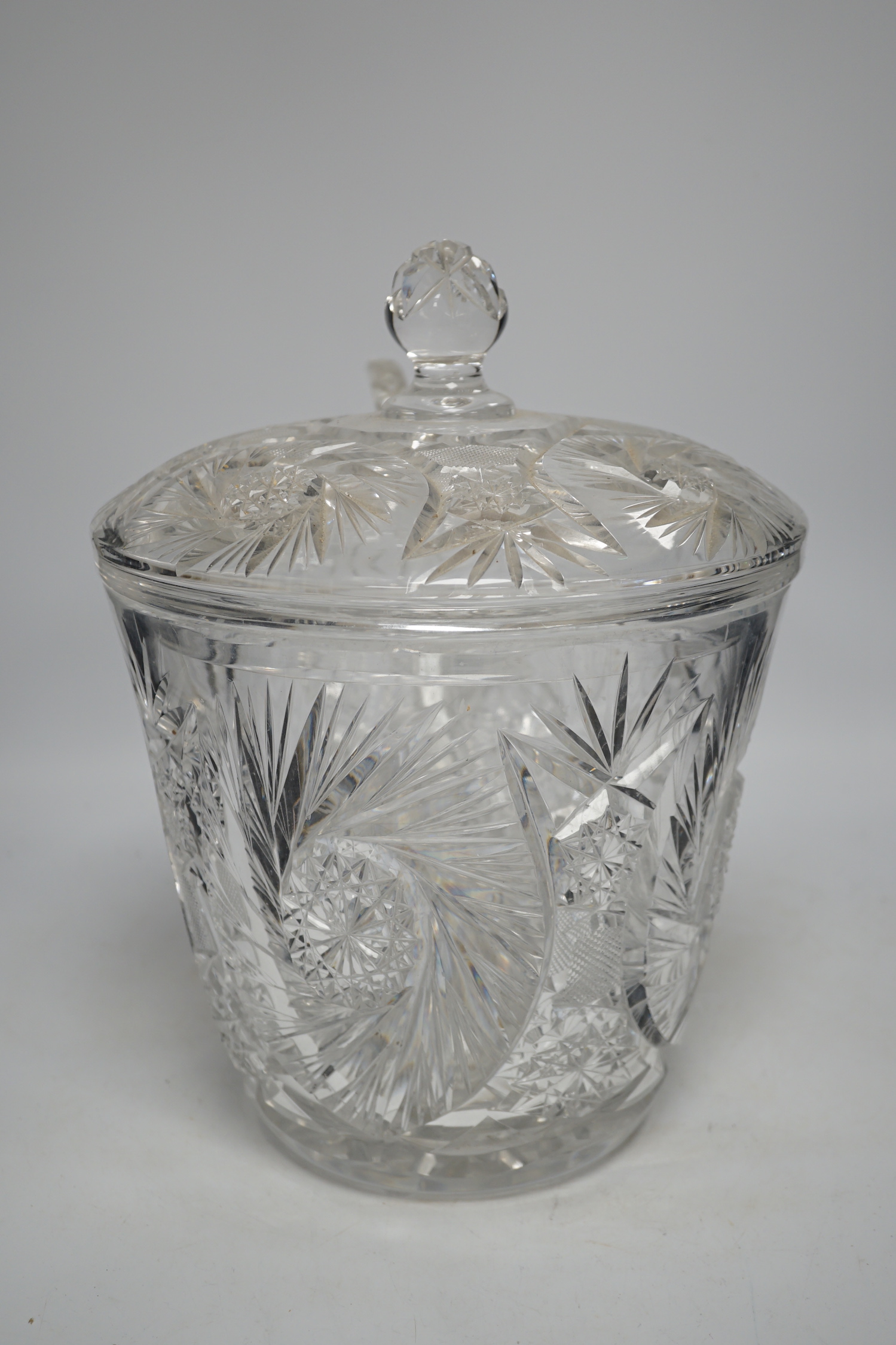 A large and heavy slice-cut lead crystal punch jar and cover, together with a ladle, 33cm